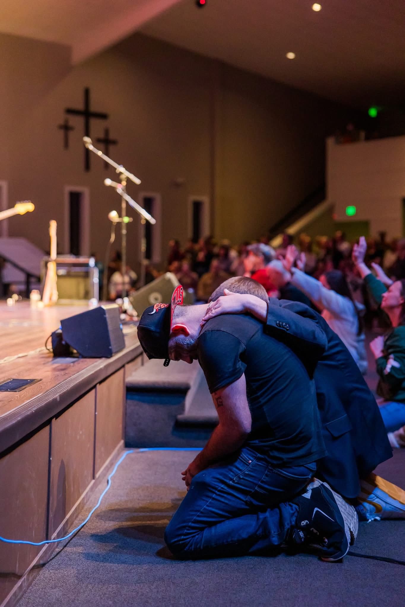 People praying together at an altar, seeking spiritual encouragement