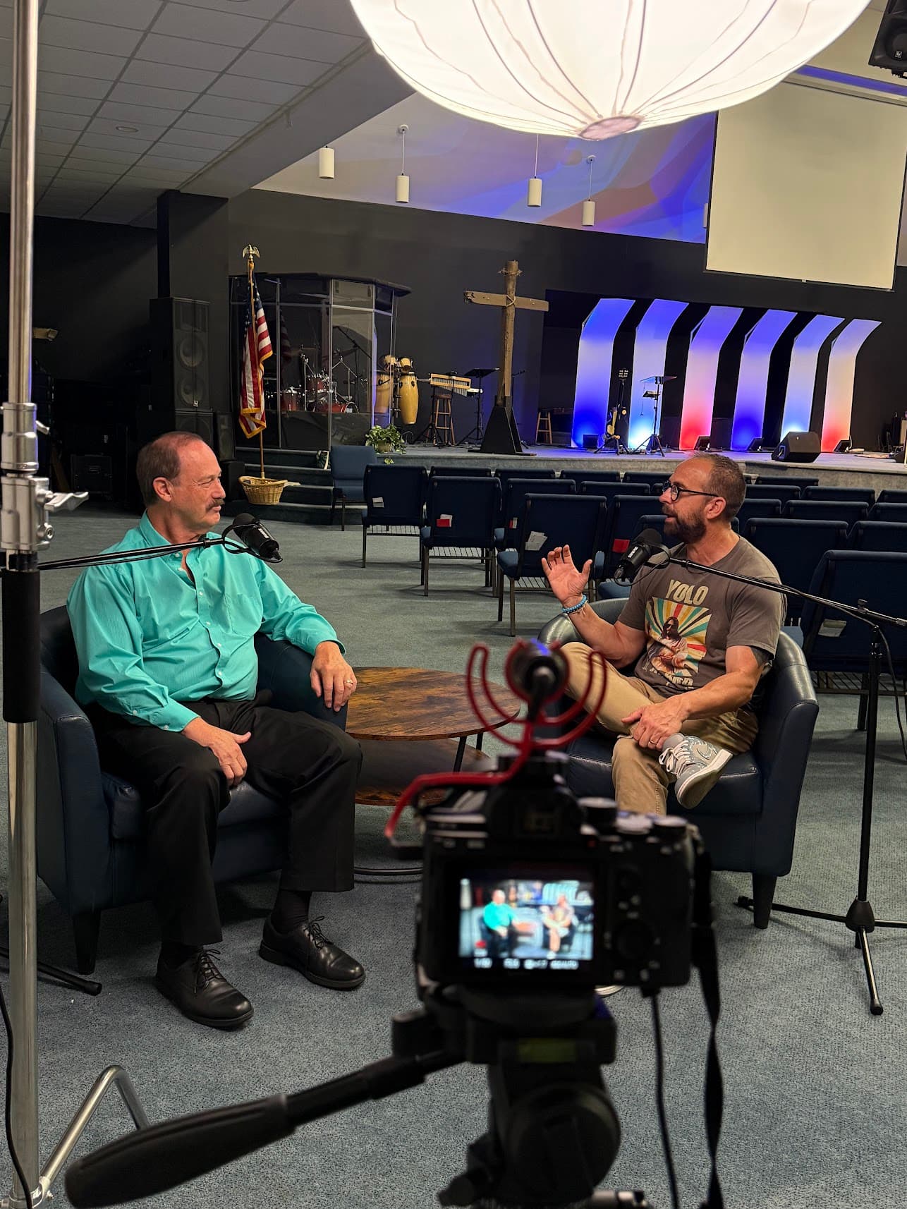 Camera viewfinder showing a podcast interview in progress