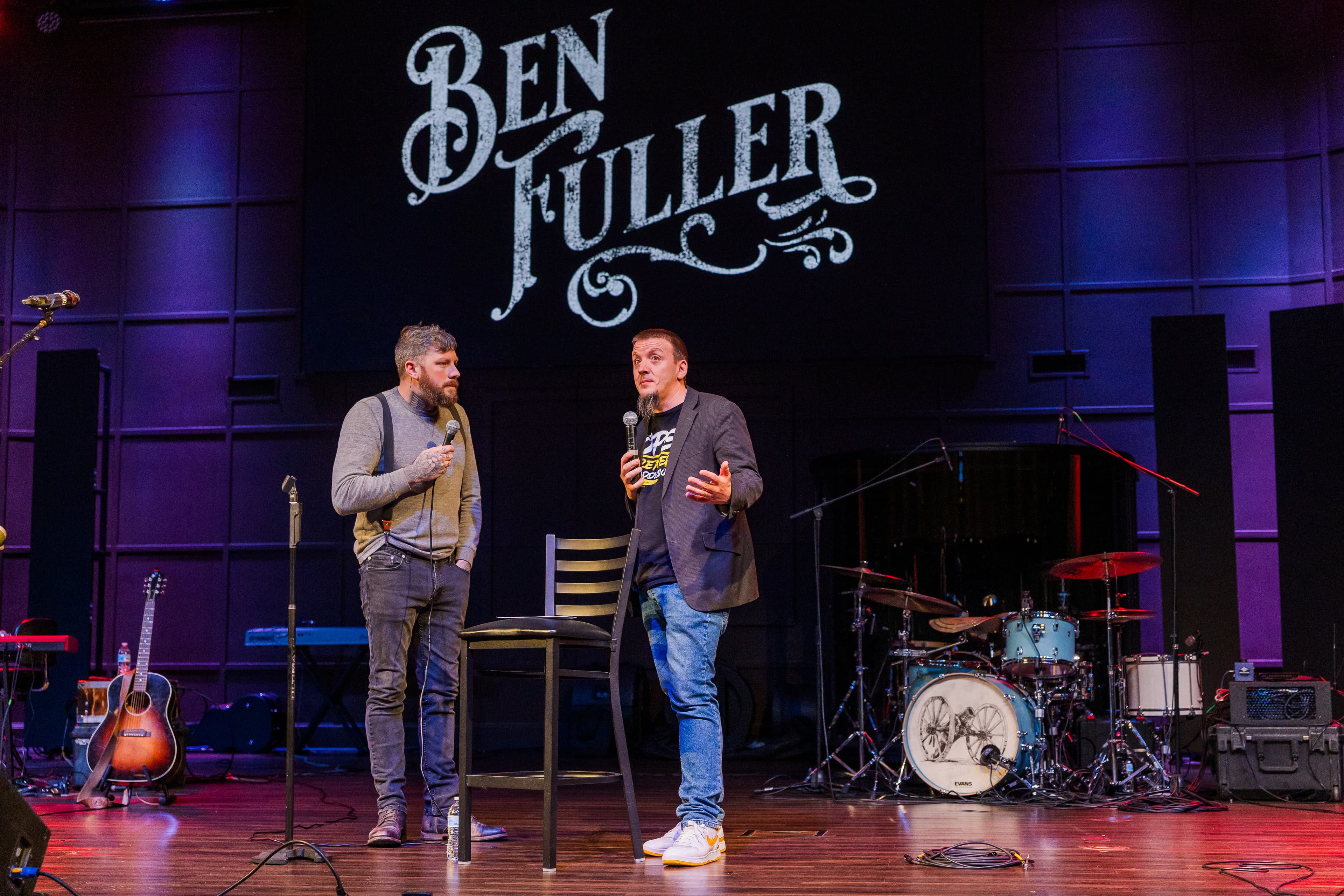 Justin and Ben Fuller with microphones on stage