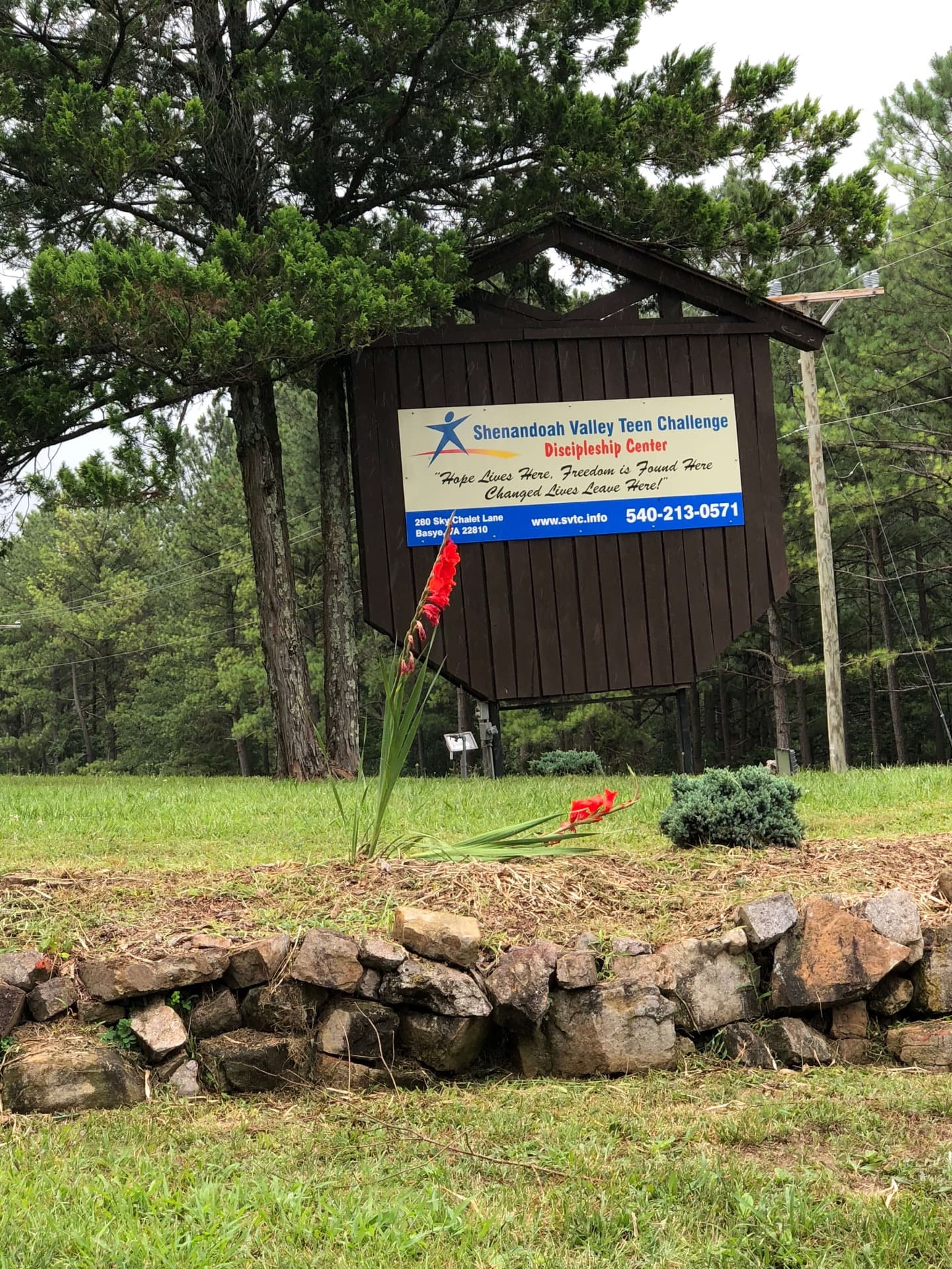 Shenandoah Valley Teen Challenge campus entrance sign surrounded by green landscape
