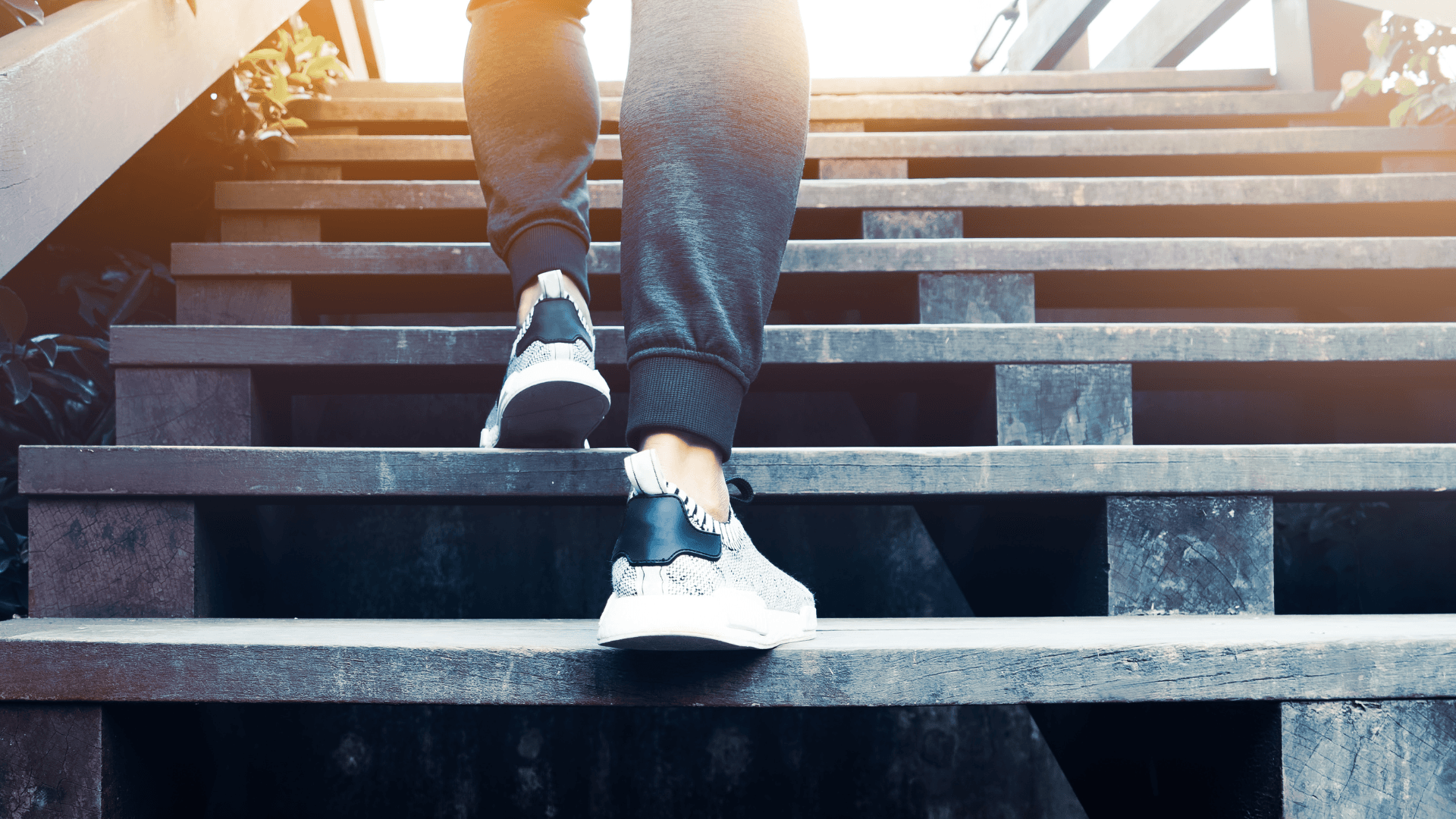 Man in sweats walking up 5 steps