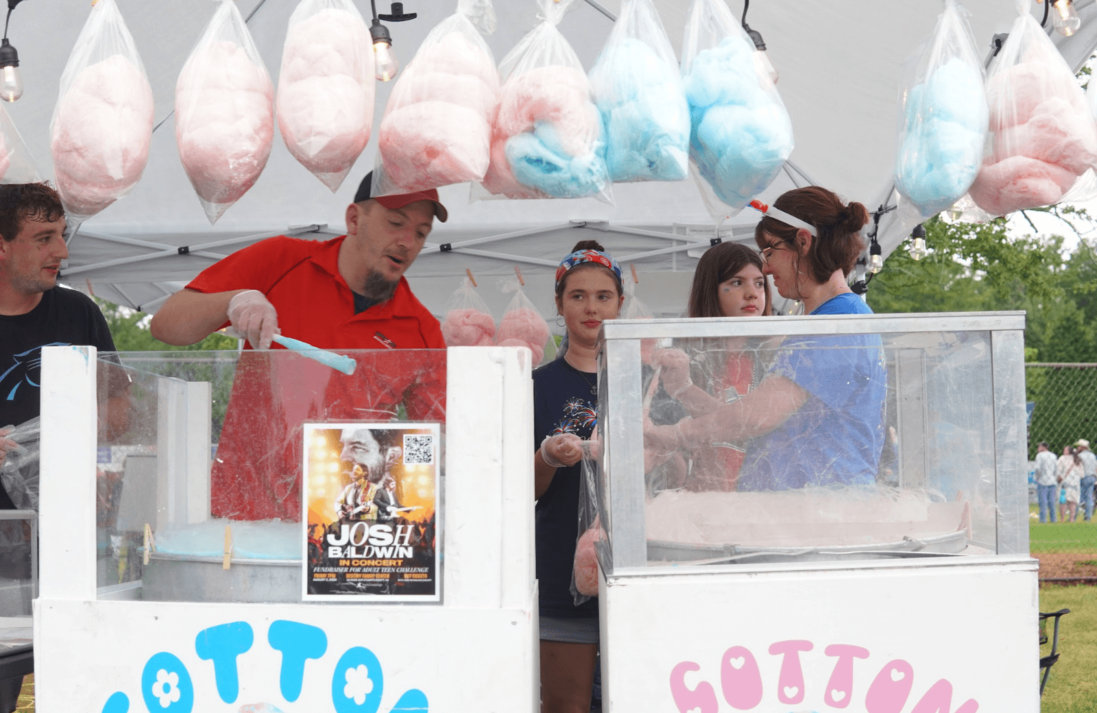 Family working together at a cotton candy booth during a Teen Challenge fundraiser event